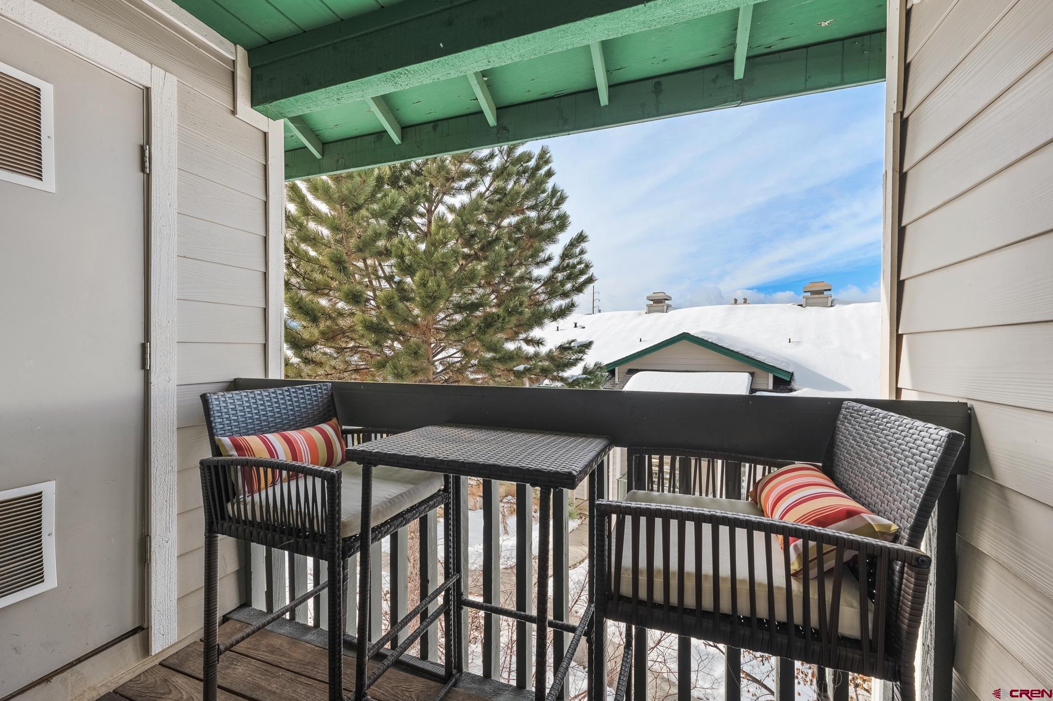 1100 Goeglein Gulch Road, Unit 206 Durango, CO 81301 - Photo 23 of 29 a view of a chairs and table in the balcony