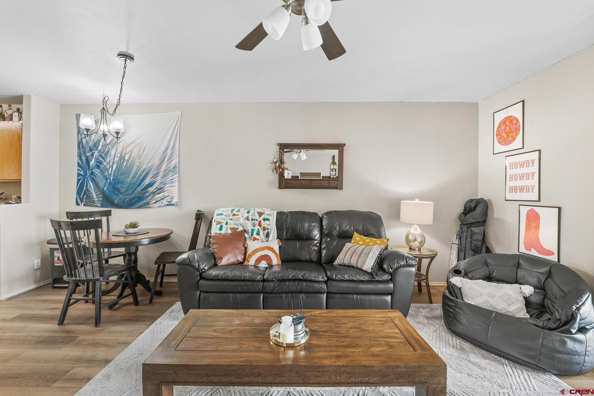 1100 Goeglein Gulch Road, Unit 206 Durango, CO 81301 - Photo 3 of 29 a living room with furniture a rug and a chandelier