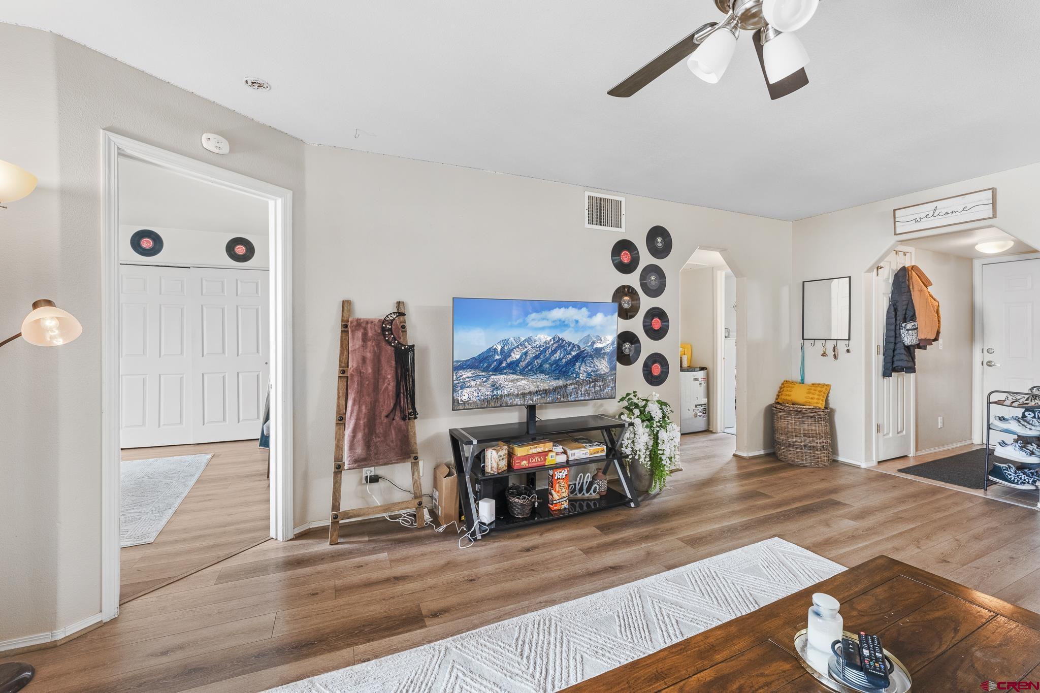 1100 Goeglein Gulch Road, Unit 206 Durango, CO 81301 - Photo 4 of 29 a view of a livingroom with wooden floor and a ceiling fan