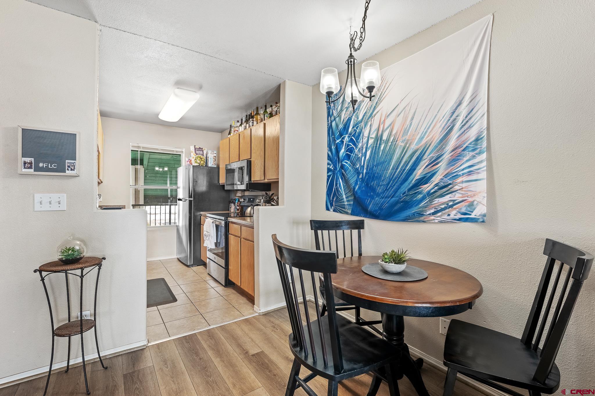 1100 Goeglein Gulch Road, Unit 206 Durango, CO 81301 - Photo 6 of 29 a view of a dining room with furniture and wooden floor