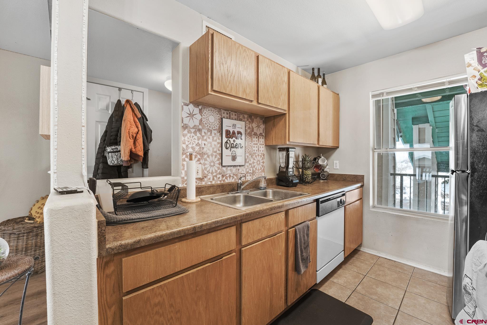 1100 Goeglein Gulch Road, Unit 206 Durango, CO 81301 - Photo 8 of 29 a kitchen with a sink cabinets and a window