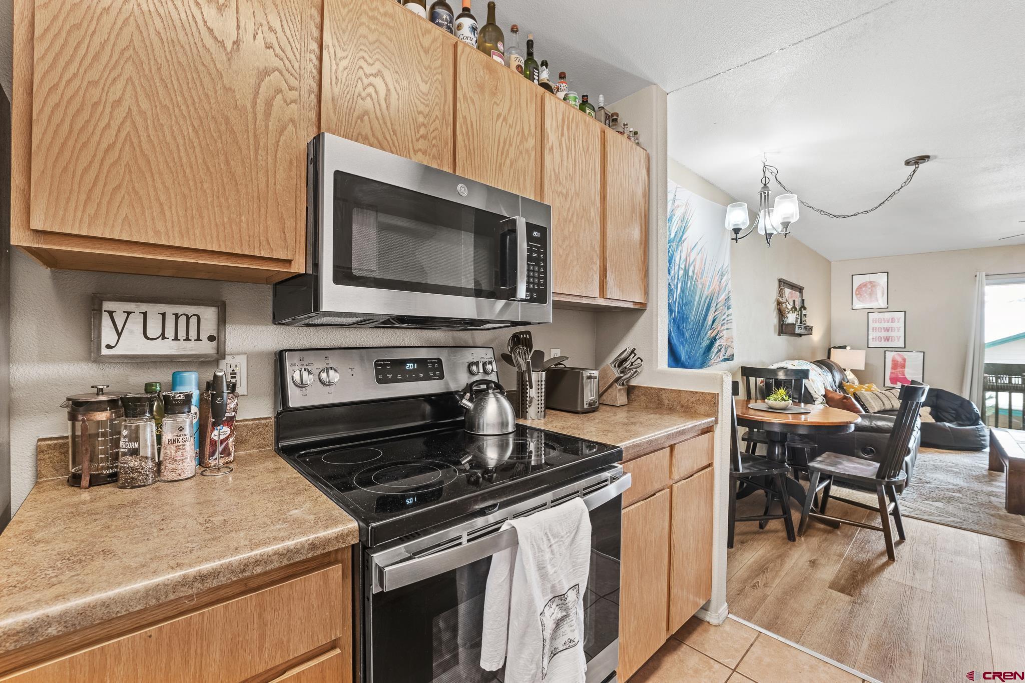 1100 Goeglein Gulch Road, Unit 206 Durango, CO 81301 - Photo 9 of 29 a kitchen with a stove a sink and a microwave
