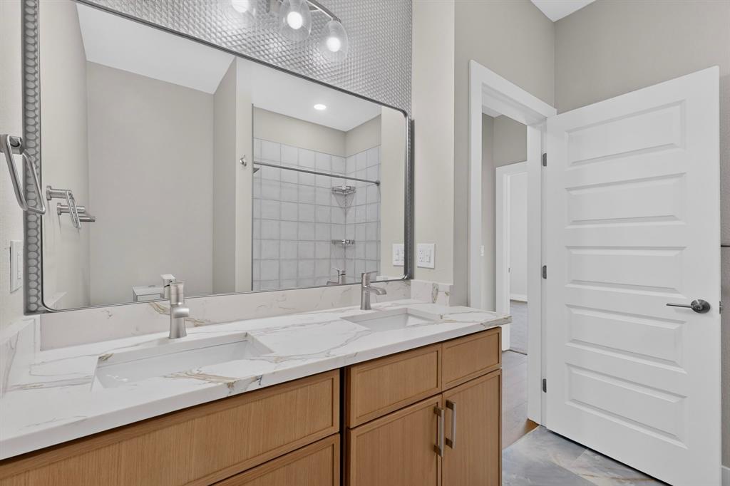 108 Winding Way Azle, TX 76020 - Photo 22 of 38 Dual vanity with integrated sinks, brushed nickel fixtures, wood-finish cabinetry, and a framed mirror