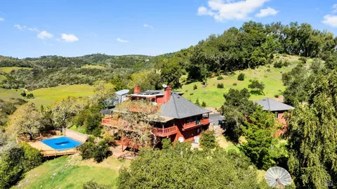 an aerial view of a house with mountain view
