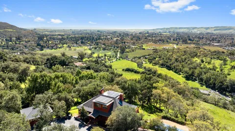 an aerial view of a house with a yard