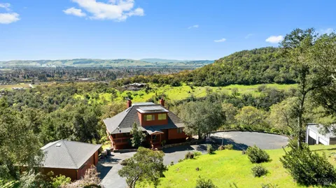 an aerial view of a house with a yard