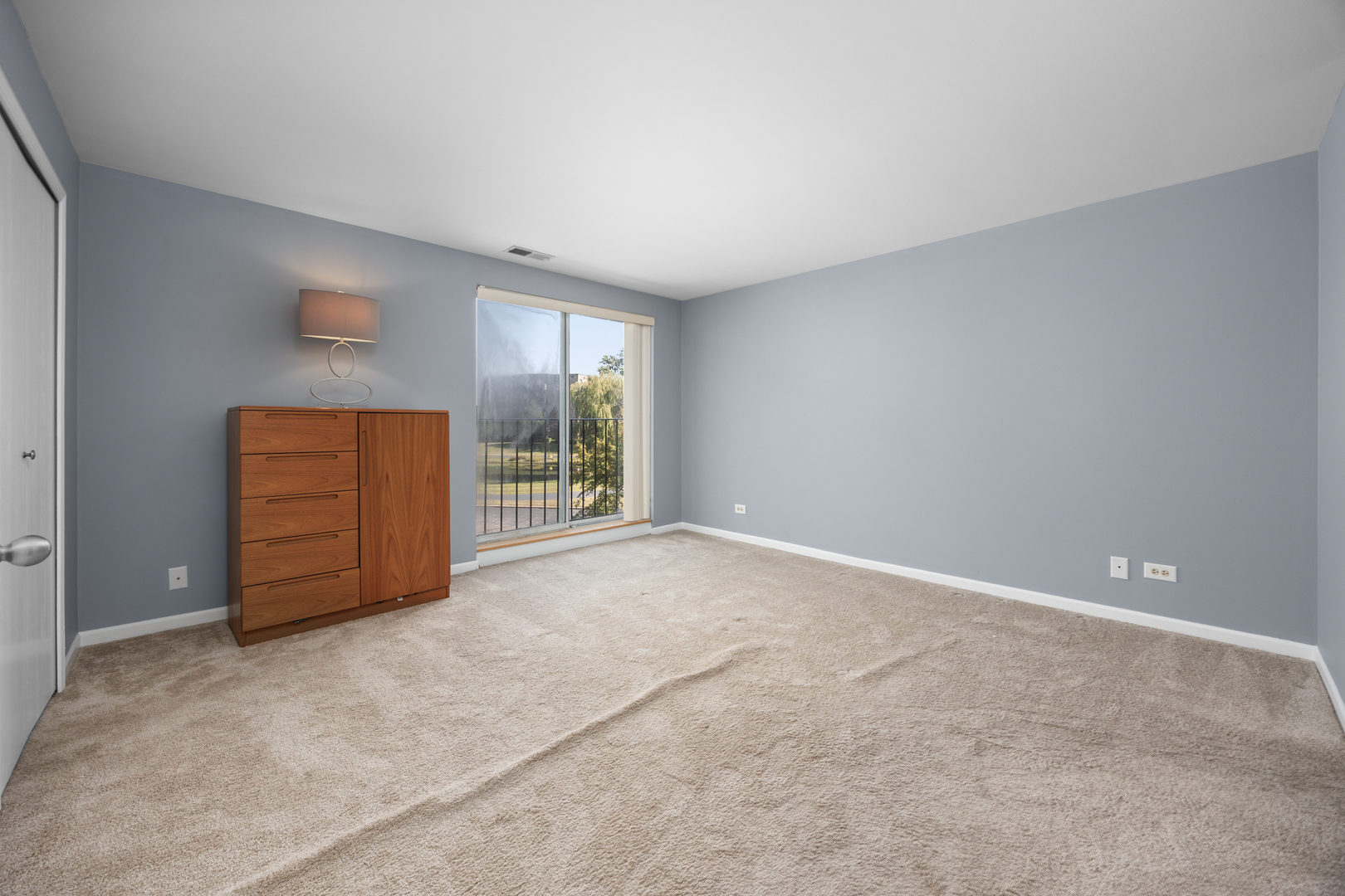 815 Leicester Road, Unit 219 Elk Grove Village, IL 60007 - Photo 14 of 26 a view of an empty room with a window