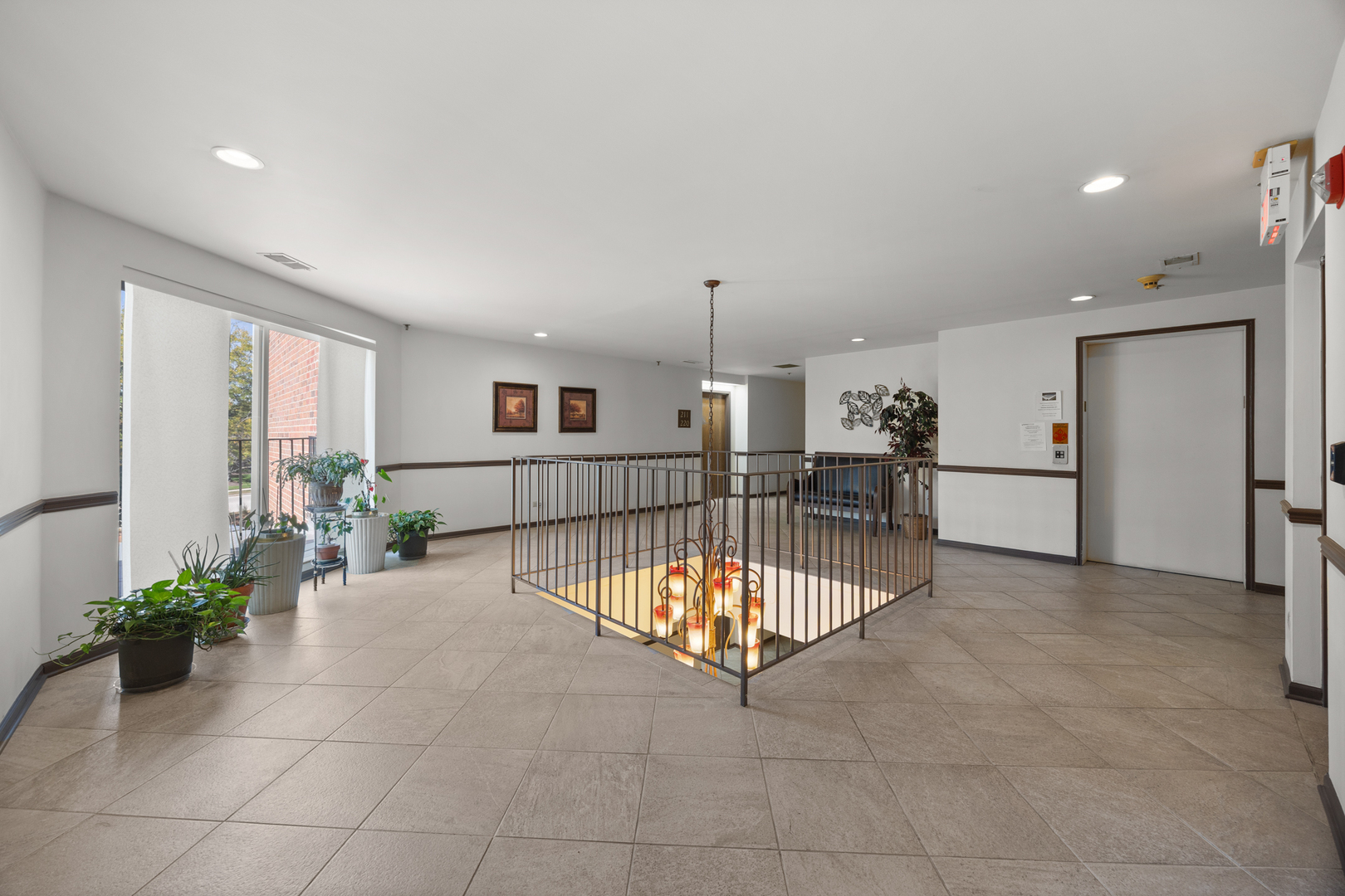 815 Leicester Road, Unit 219 Elk Grove Village, IL 60007 - Photo 25 of 26 a view of an empty room with kitchen and a window