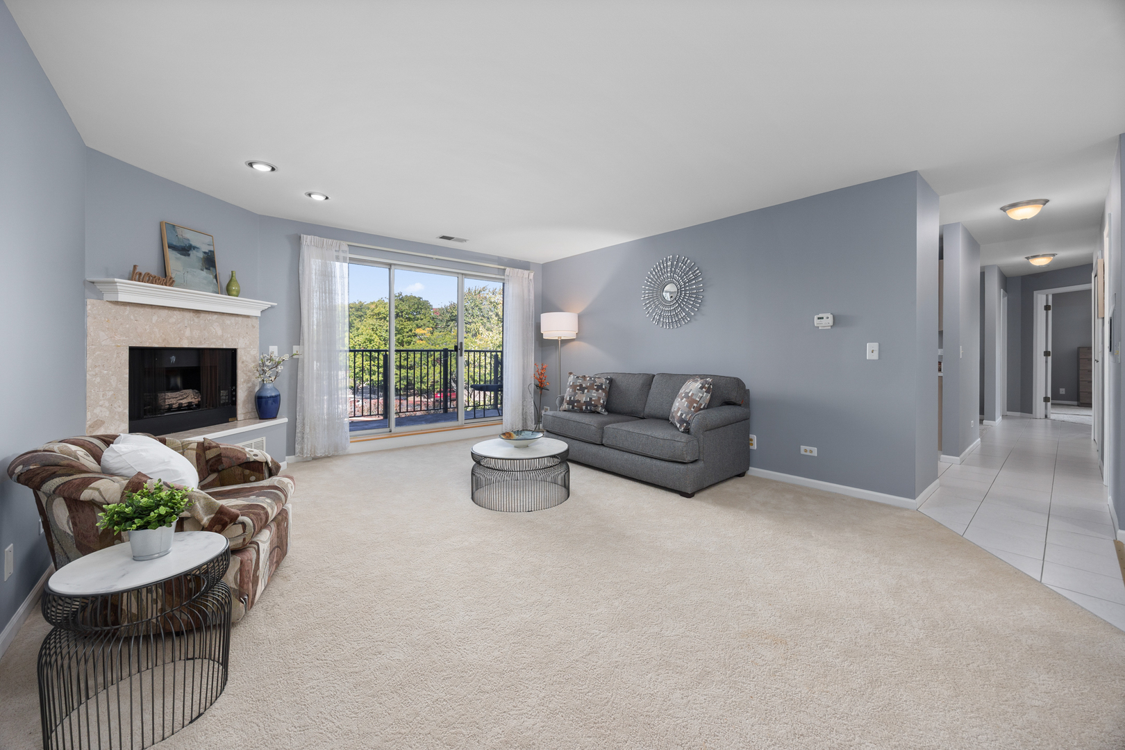 815 Leicester Road, Unit 219 Elk Grove Village, IL 60007 - Photo 3 of 26 a living room with furniture and a fireplace