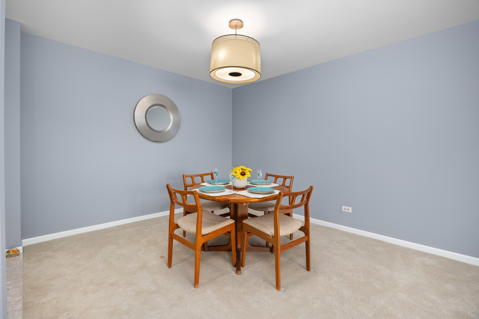 815 Leicester Road, Unit 219 Elk Grove Village, IL 60007 - Photo 6 of 26 a dining room with a table and chandelier
