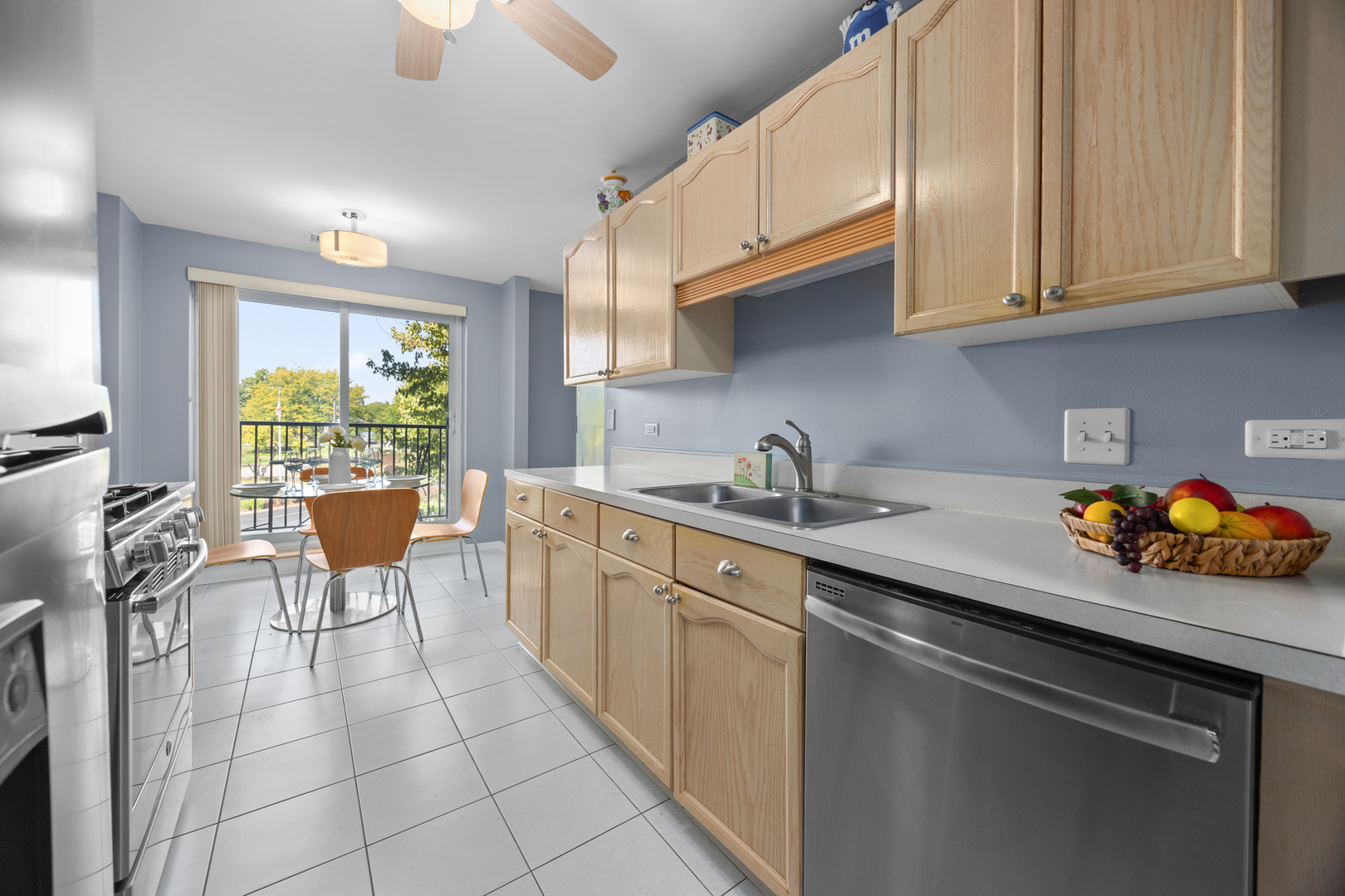 815 Leicester Road, Unit 219 Elk Grove Village, IL 60007 - Photo 7 of 26 a kitchen with a sink a window and cabinets