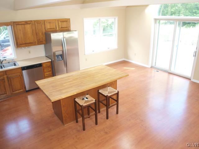 4952 Cedar Grove Road Bangor, PA 18013 - Photo 22 of 50 a kitchen with stainless steel appliances wooden floor and a refrigerator