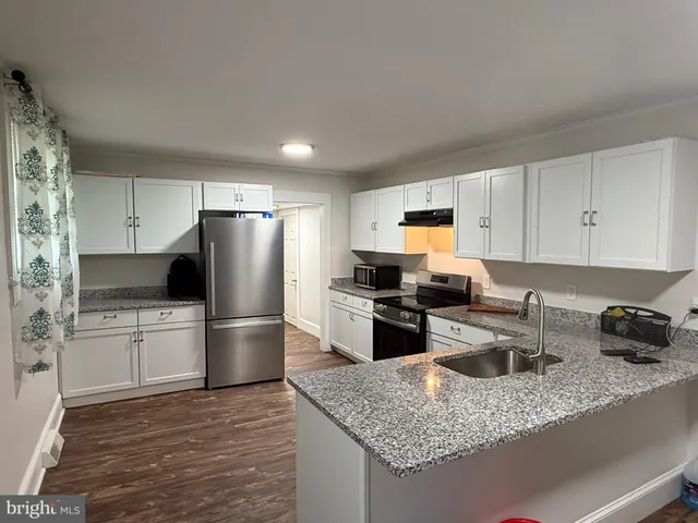 a kitchen with a refrigerator sink and stove