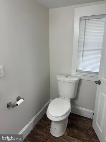 a white toilet sitting next to a bathroom sink