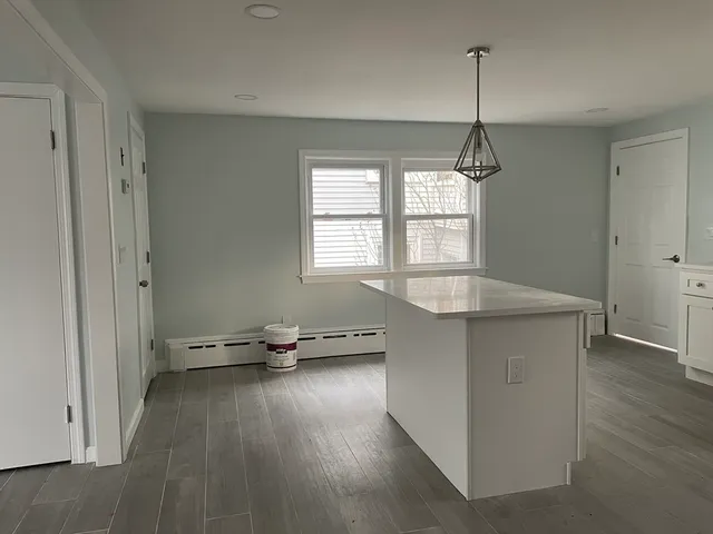 a kitchen with a refrigerator a stove and a sink