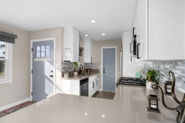 a kitchen with sink and cabinets