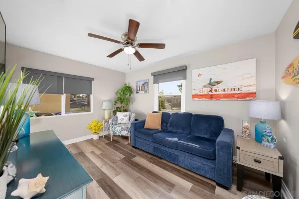 a living room with furniture and a wooden floor