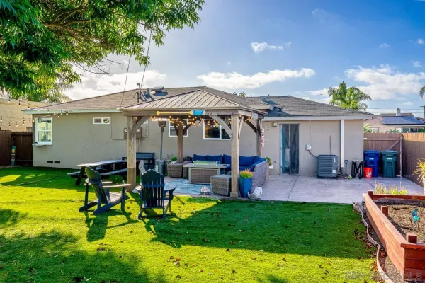 a view of a house with a backyard patio and swimming pool
