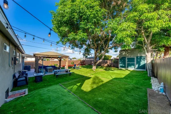 a view of a house with a backyard porch and sitting area