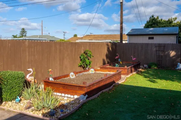 a view of a backyard with plants and a patio