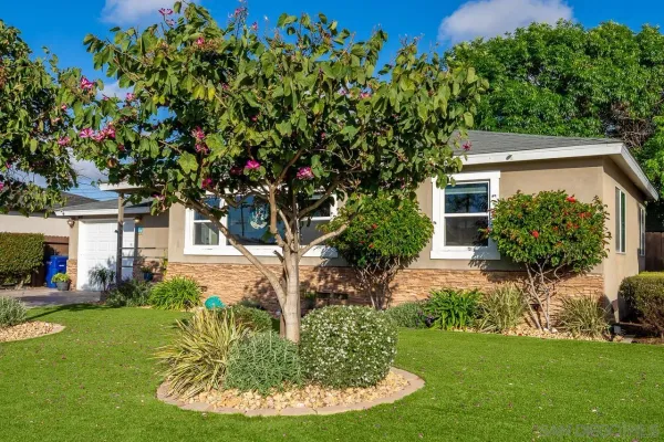 a view of a house with backyard sitting area and garden