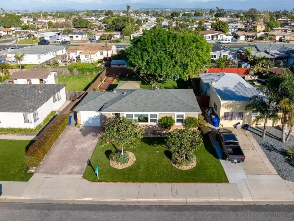 an aerial view of residential houses with outdoor space