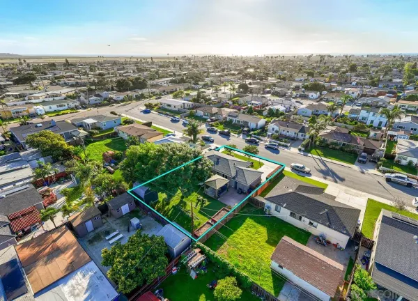 an aerial view of residential houses with yard