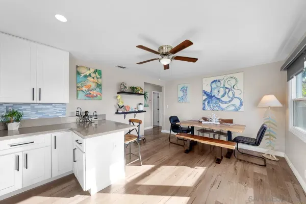 a living room with furniture and wall paintings