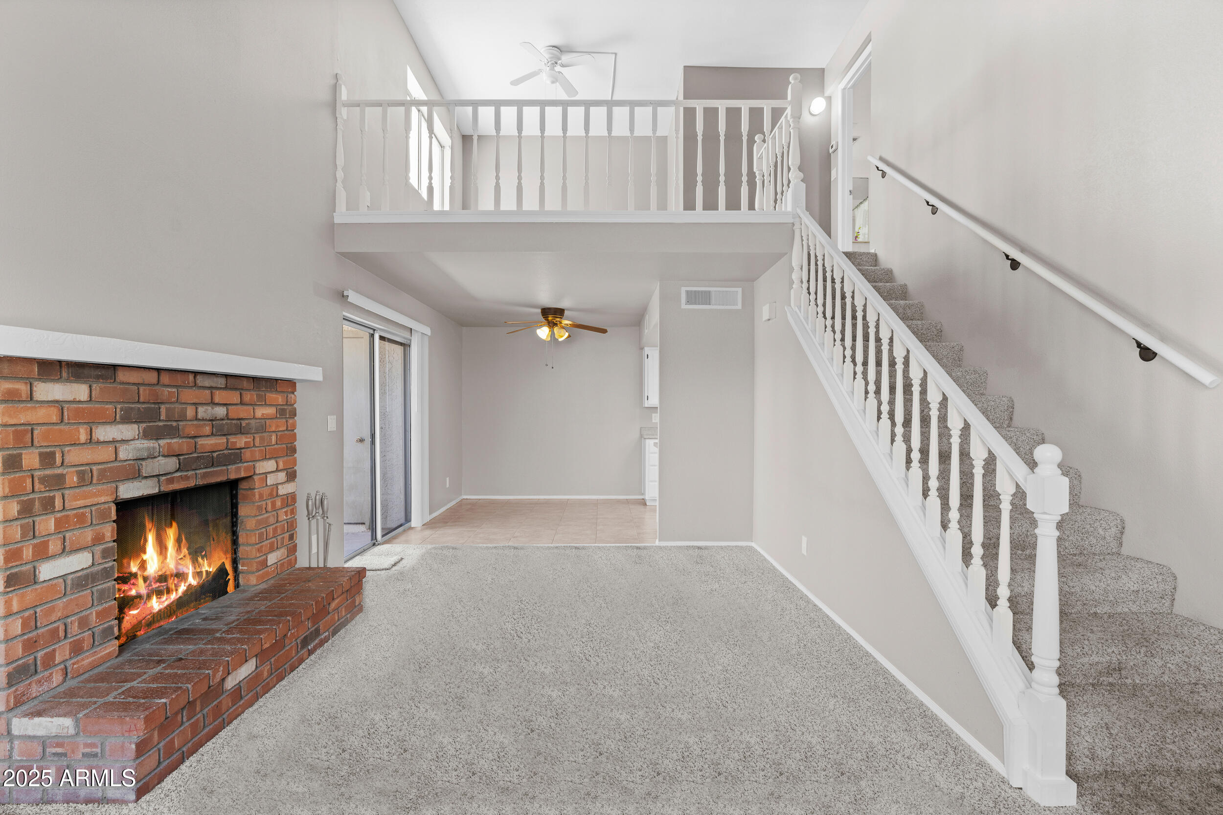 222 West Brown Road, Unit 36 Mesa, AZ 85201 - Photo 2 of 16 a view of an empty room wooden floor fireplace and a window
