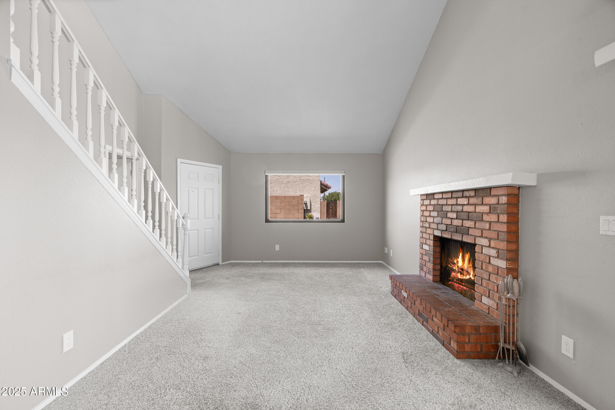 222 West Brown Road, Unit 36 Mesa, AZ 85201 - Photo 3 of 16 a view of an empty room with fire place and a fireplace