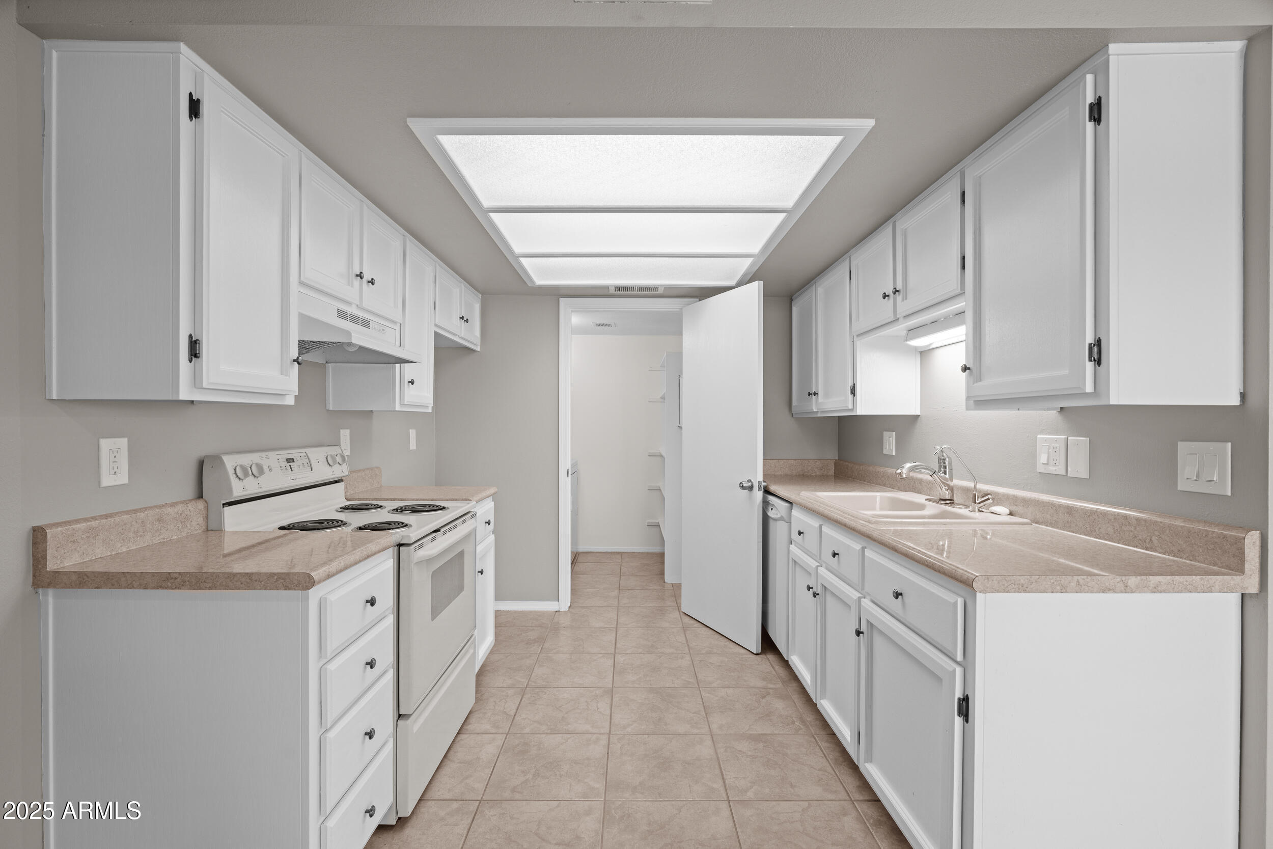 222 West Brown Road, Unit 36 Mesa, AZ 85201 - Photo 4 of 16 a kitchen with granite countertop a sink stove and cabinets