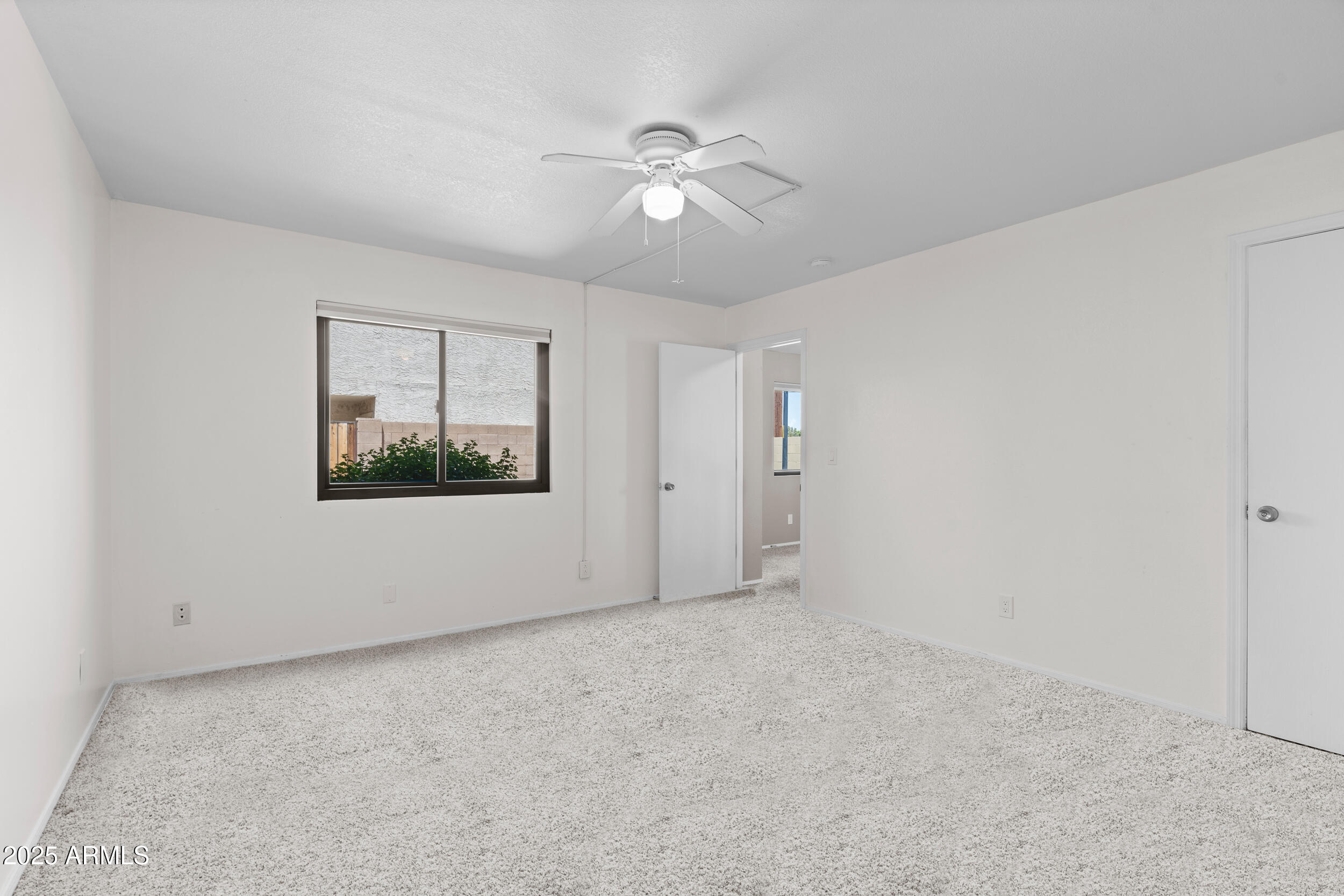 222 West Brown Road, Unit 36 Mesa, AZ 85201 - Photo 10 of 16 a view of an empty room with a window