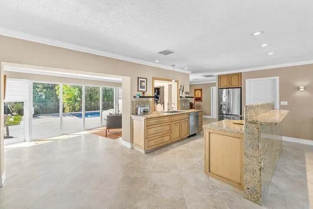 a large white room with kitchen island and a large window