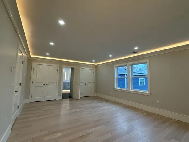 a bathroom with a granite countertop sink a mirror a bathtub and shower