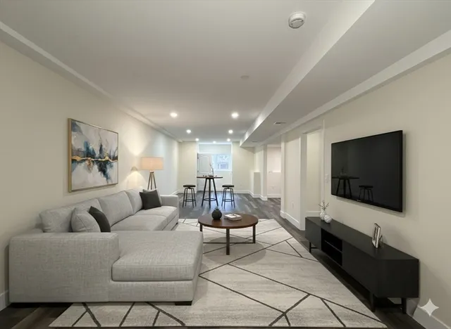 a living room with furniture gym equipment and a flat screen tv