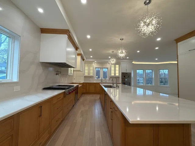 a view of a kitchen with granite countertop a refrigerator and a sink