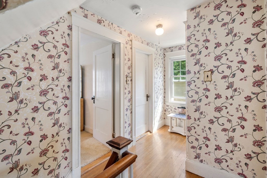 46 Rowe Street Milton, MA 02186 - Photo 13 of 20 wooden floor with a view of a bathroom