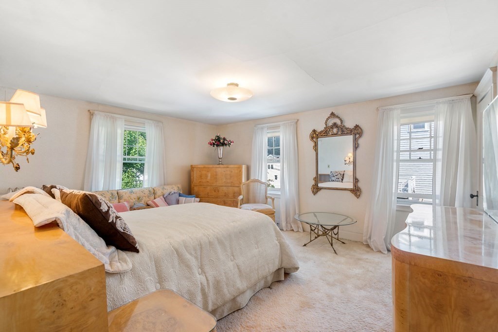 46 Rowe Street Milton, MA 02186 - Photo 14 of 20 a bedroom with a bed and wooden floor