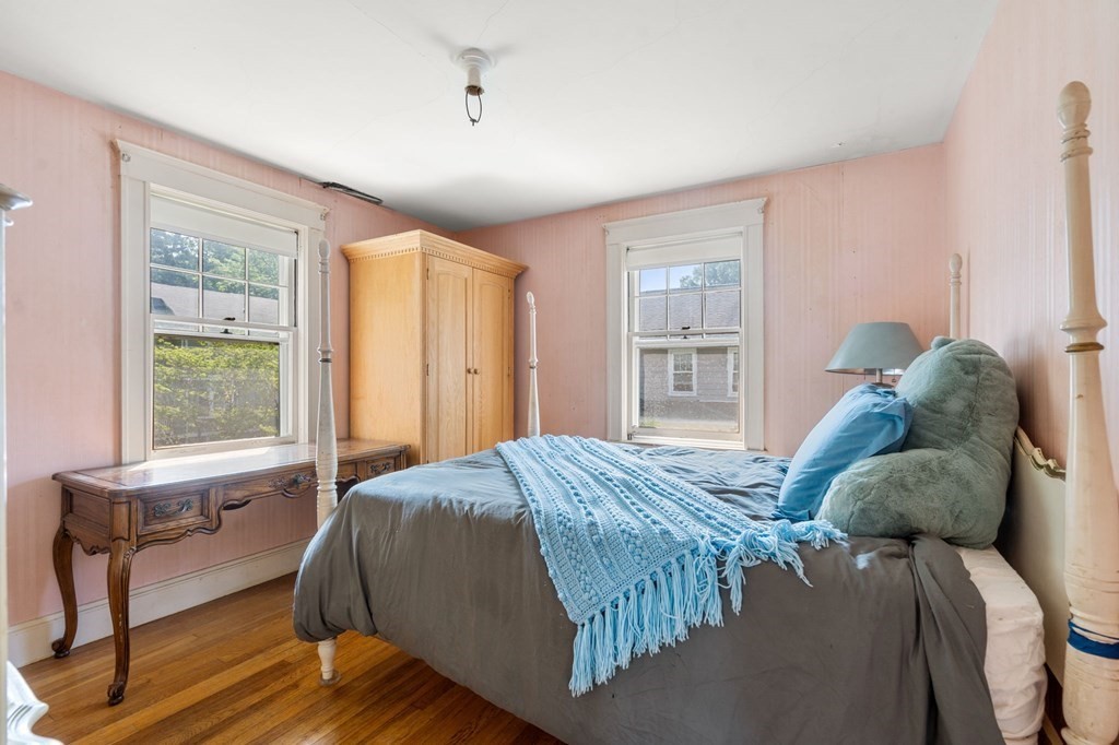 46 Rowe Street Milton, MA 02186 - Photo 16 of 20 a bed sitting in a spacious bedroom next to a window