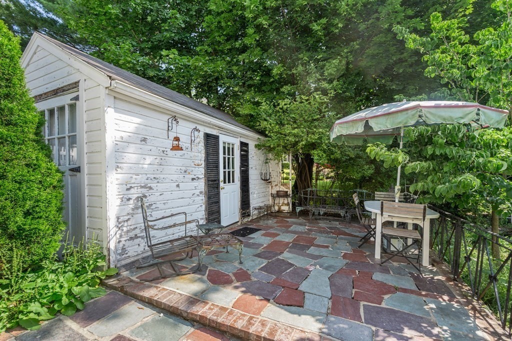 46 Rowe Street Milton, MA 02186 - Photo 20 of 20 a backyard of a house with table and chairs
