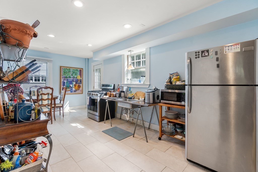 46 Rowe Street Milton, MA 02186 - Photo 10 of 20 a kitchen with stainless steel appliances granite countertop a refrigerator and a sink