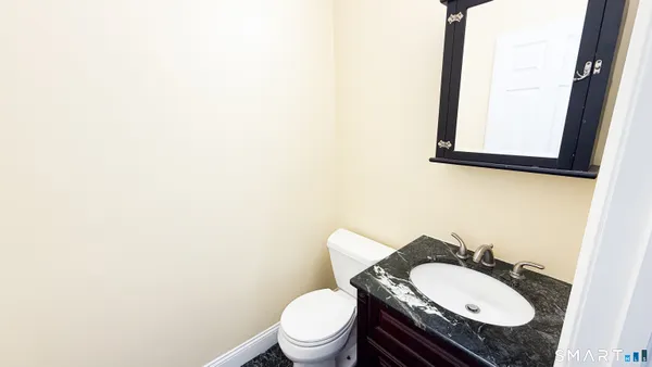 an empty room with wooden floor and closet area
