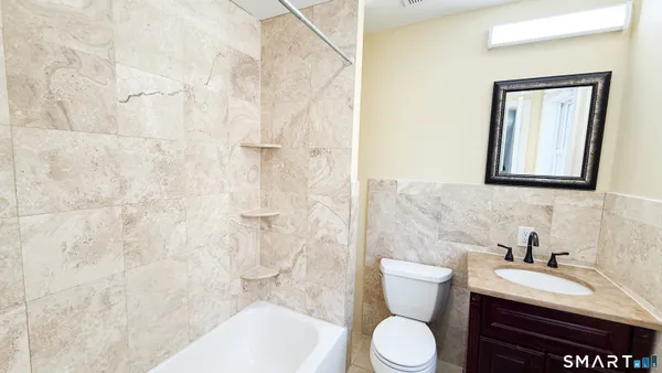 a bathroom with a sink a toilet and a bathtub