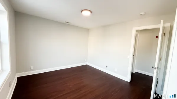 a kitchen with a refrigerator and a stove top oven