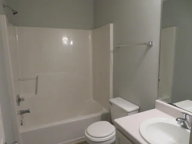 a bathroom with a toilet a sink and bathtub