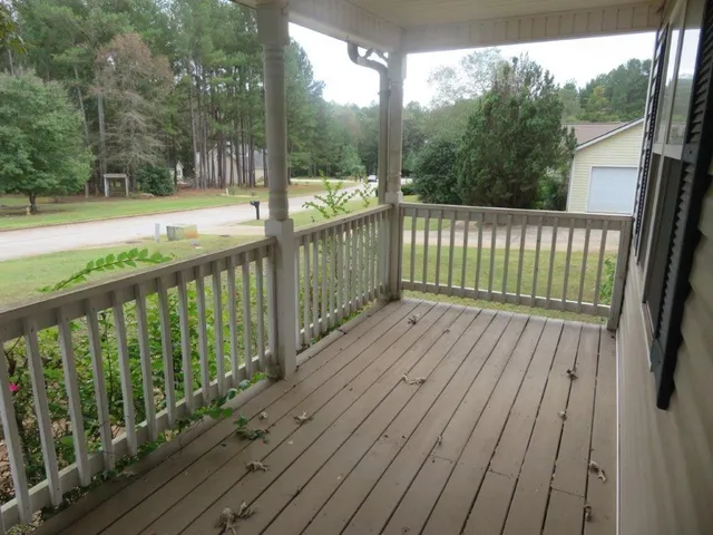 a view of backyard with deck and wooden floor
