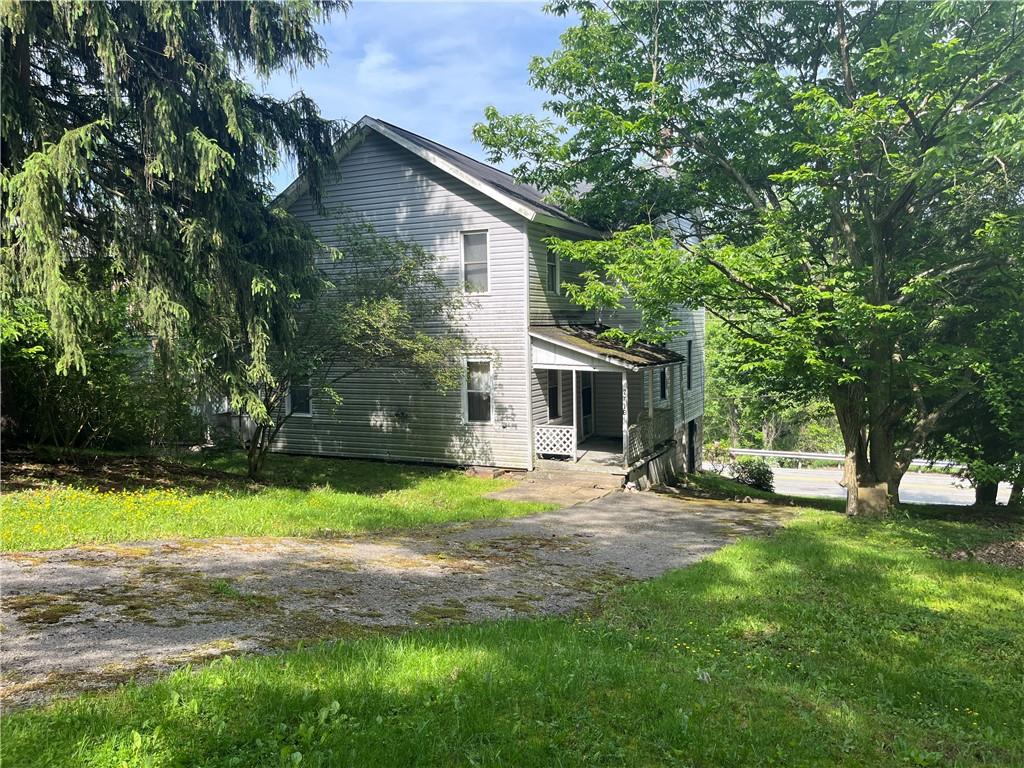271-a Wendel Road Irwin, PA 15642 - Photo 3 of 19 a front view of a house with a yard and trees