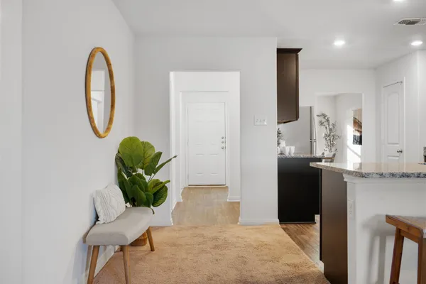 a living room with furniture and a mirror