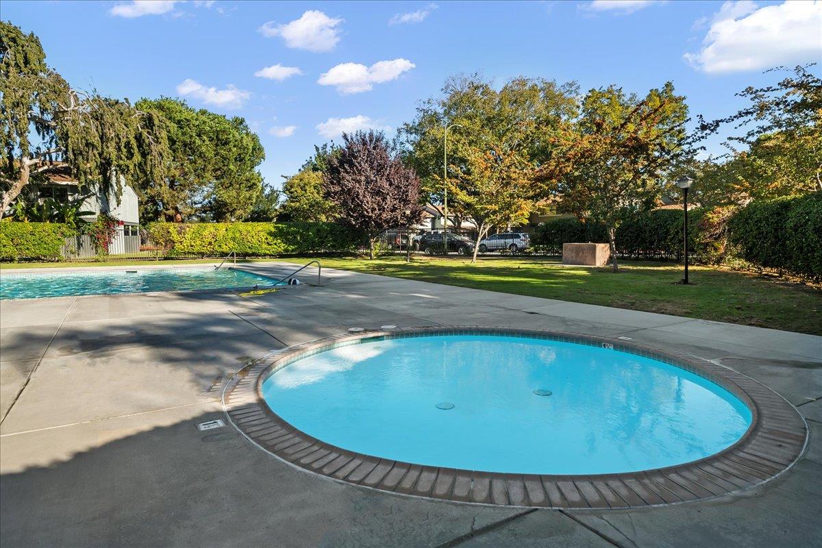 4790 Raspberry Place San Jose, CA 95129 - Photo 33 of 45 a view of a swimming pool with a yard and trees in the background