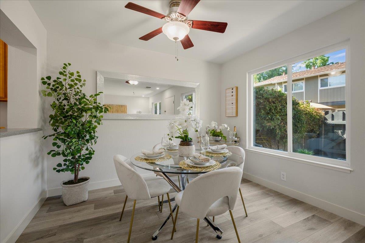 4790 Raspberry Place San Jose, CA 95129 - Photo 7 of 45 a dining room with furniture potted plants and wooden floor